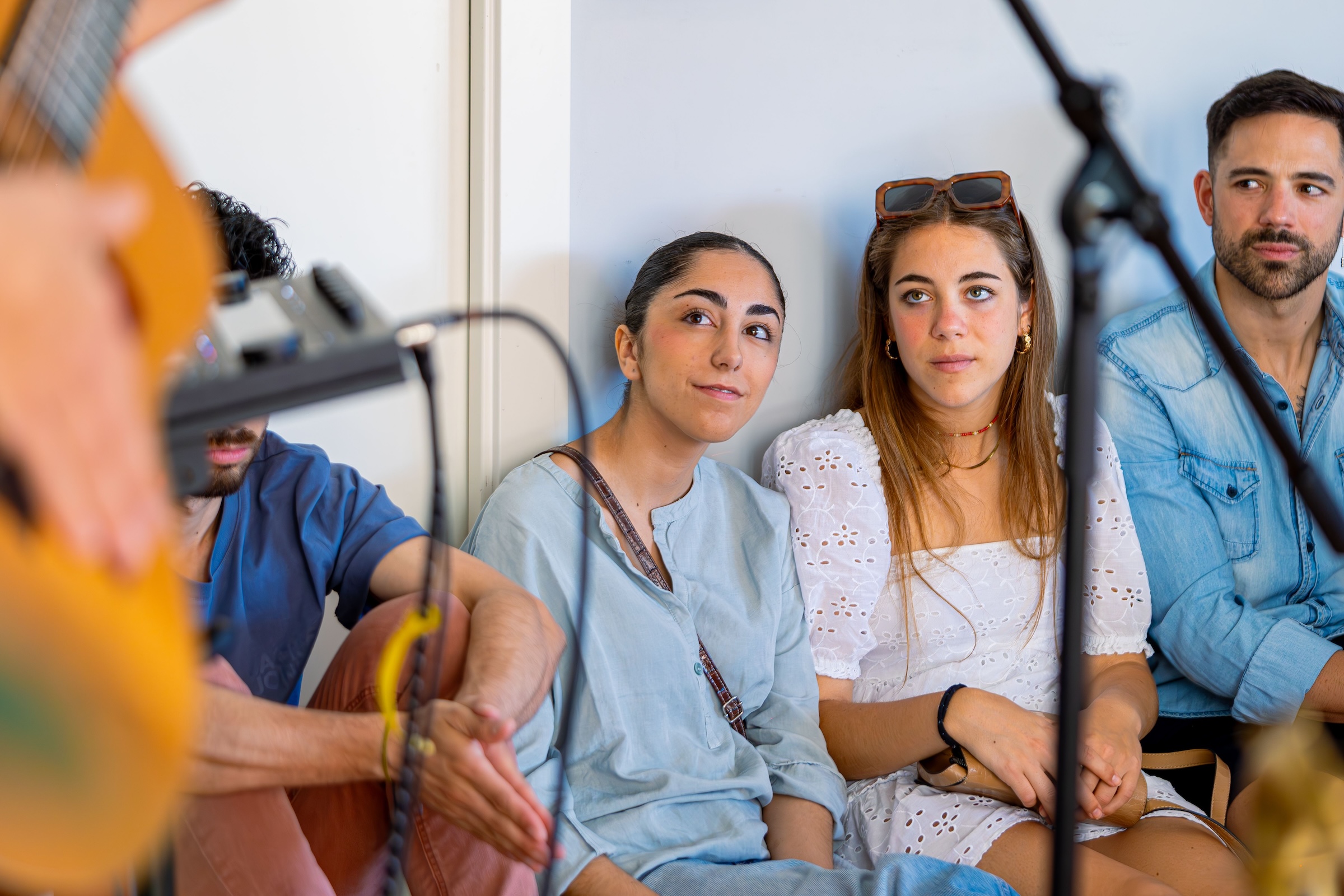 People listening with attention to musicians and a singer.
